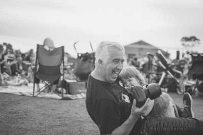 cute black and white pick of toddler and dad with camera