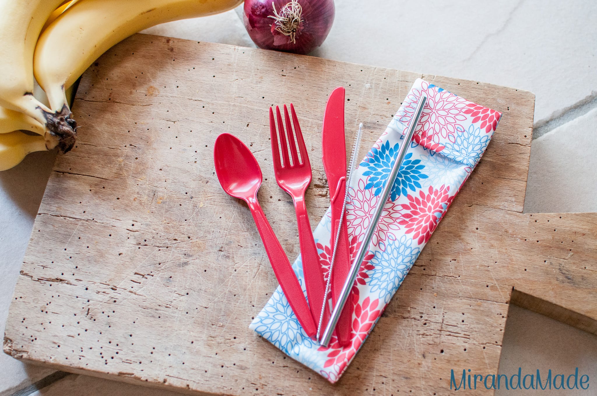 Red and blue floral pouch with red cutlery and stainless steel straw
