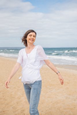 Happy smiling women walks along the beach